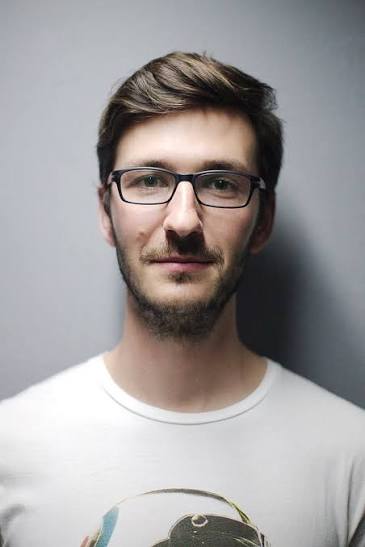 Portrait of Jonas K. wearing glasses